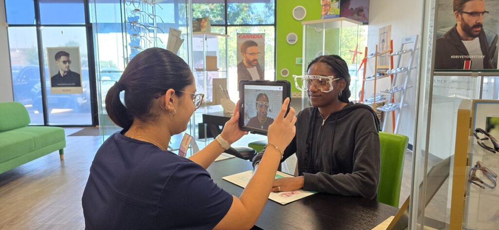 Optician performing digital frame fitting with tablet at Vision Source Crystal Falls in Leander, TX